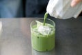 Iced matcha latte - A glass of green tea with milk on the table. Royalty Free Stock Photo