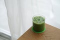 Iced matcha latte - A glass of green tea with milk on the table. Royalty Free Stock Photo