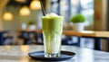 Iced Matcha Latte Tea with Milk, tall glass on table Royalty Free Stock Photo