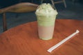 Iced Matcha latte tea on wooden table Royalty Free Stock Photo