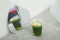 Iced matcha lemon soda - A plastic glass of green tea mixed with honey lemon soda on the table Royalty Free Stock Photo