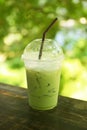 iced milk green tea on wooden table with green bokeh background Royalty Free Stock Photo