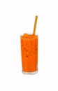 Iced milk tea color orange with crushed ice in glass on tall square with straw brown. Royalty Free Stock Photo