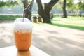 Iced milk tea with plastic takeaway glass on wood table Royalty Free Stock Photo