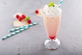 Iced milkshake with raspberry syrup and whipped cream Royalty Free Stock Photo