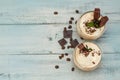 Iced Mocha Frappe Coffee with Whip Cream, Summer Drinking times. Coffee Beans. rustic textured Wooden Background. Mint Leaves Copy