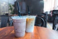 Iced Mocha and Iced Latte coffee drinks in clear plastic cups wi