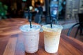 Iced Mocha and Iced Latte coffee drinks in clear plastic cups wi