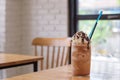 iced mocha with straw in tall glass on wooden table & x28;coffee, ice