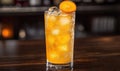 Iced orange cocktail with fruit garnish on bar Royalty Free Stock Photo