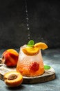 iced peach cocktail with peach slices, summer Peach cocktail, homemade peach lemonade with ice cubes, and mint in glass Royalty Free Stock Photo