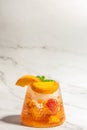 Iced peach cocktail with peach slices, summer Peach cocktail, homemade peach lemonade with ice cubes, and mint in glass Royalty Free Stock Photo