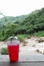 Iced red soda in a plastic cup