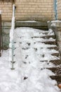 Iced stairs. Snow covered entrance. Old steps.