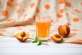 iced tea with apricot halves, fresh apricots on cloth