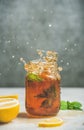 Iced tea with bergamot, lemon, mint in jar with splashes Royalty Free Stock Photo