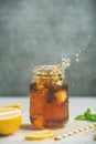 Iced tea with bergamot and mint in jar with splashes Royalty Free Stock Photo