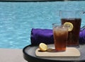 Iced Tea Beverage with Lemon by the Pool with Purpler Towel