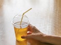 Iced tea in a clear plastic cup. Kombucha drink