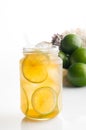 Delicious Iced tea with lemon in glass jar on white background and lemon slices Royalty Free Stock Photo