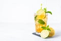 Iced tea with lemon, lime, mint and ice.