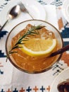 Iced tea with lemon and rosemary in a glass bowl. Royalty Free Stock Photo