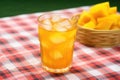 iced-tea with mango chunks on a checkered tablecloth Royalty Free Stock Photo