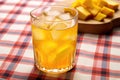 iced-tea with mango chunks on a checkered tablecloth Royalty Free Stock Photo