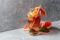 Iced tea with mint and grapefruit on a grey background