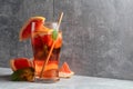 Iced tea with mint and grapefruit on a grey background