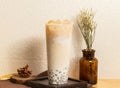 Iced Winter Melon Fresh Milk Taro tea served in disposable glass isolated on wooden board side view of taiwanese ice drink Royalty Free Stock Photo