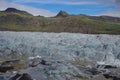 Iceland arrival of a glacier in green and brown mountain background