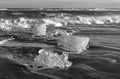 Iceland Diamond beach near Jokulsarlon Glacier Lagoon pieces of ice washed up on the black sand beach in black and white Royalty Free Stock Photo