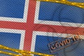 Iceland flag and Covid-19 biohazard symbol with quarantine orange tape and stamp. Coronavirus or 2019-nCov virus concept