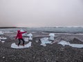 Iceland - Girl surfing on an ice piece Royalty Free Stock Photo