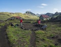 Iceland, Hvanngil campsite, August 1, 2019: family of hikers packing their camp in lava filed on Laugavegur Trail. Green