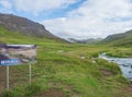 Iceland, Hveragerdi, August 5, 2019: Tourist notice sign post at entrance to Reykjadalur valley with hot springs river, lush green