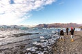 Iceland, Jokulsarlon - Oct 24th 2017 - Group of young tourist taking pictures in the edge of the iceberg lagoon of Jokulsarlon, mo
