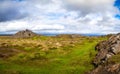 Iceland landscape with orange lava hill and green grass valley way to volcano Royalty Free Stock Photo