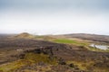 Iceland lighthouse Reykjanesviti with rocky volcanic soil gesers and grey sky