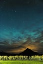 Iceland mountain with warm brown clouds and cold teal night sky Royalty Free Stock Photo