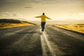 Iceland road trip. Girl is walking alone on road Royalty Free Stock Photo