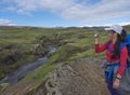 ICELAND, SKOGAR, August 4, 2019: Young asian chinese girl tourist takes picture of cascades at Skoga river valley with beautiful Royalty Free Stock Photo