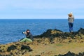 A couple of unknown tourists on the rocky seashore. Different points of view Royalty Free Stock Photo