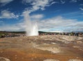 ICELAND, STROKKUR, JULY 26, 2016: Strokkur geysir eruption Golden Circle, big group of colorful dressed tourist takeing pictures