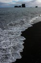 Iceland west Coast, the sea entering the black sand Royalty Free Stock Photo