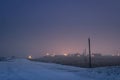 Iceland winter night landscape, snowy, road, outdoors, city lights, empty space above Royalty Free Stock Photo