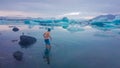 Iceland - Young man getting into the water of Glacier lagoon