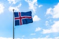 Icelandic flag, clouds, blue sky