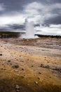 The Icelandic Geyser, Strokkur, erupting into a dramatic cloudy